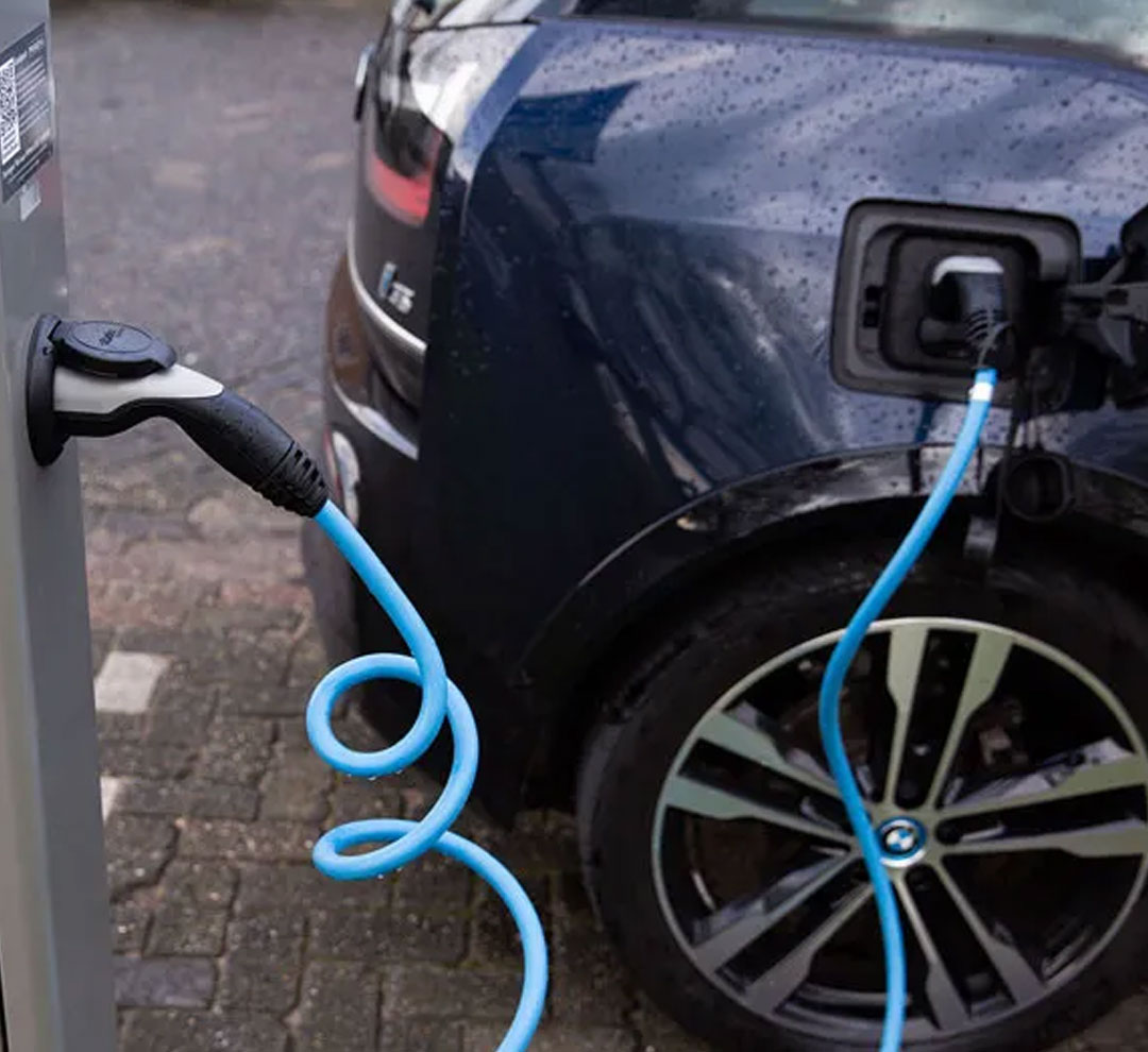 An electric car charging at a charging point