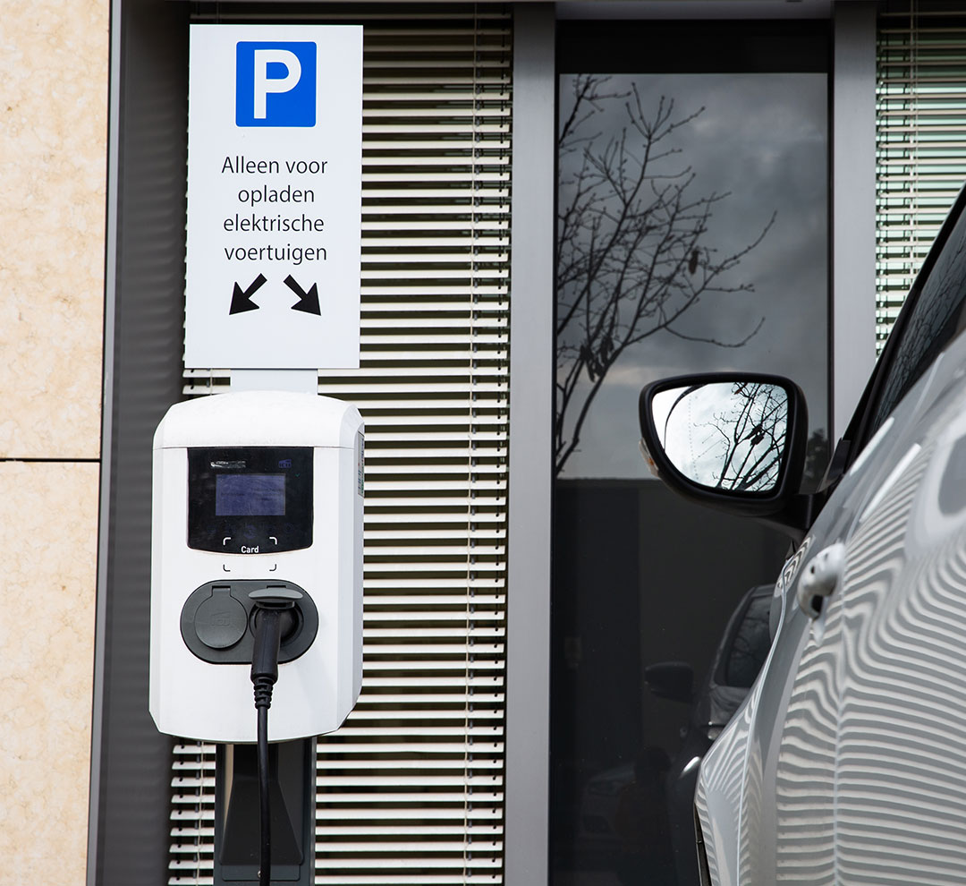 A charging location for electric vehicles with a charging sign next to it