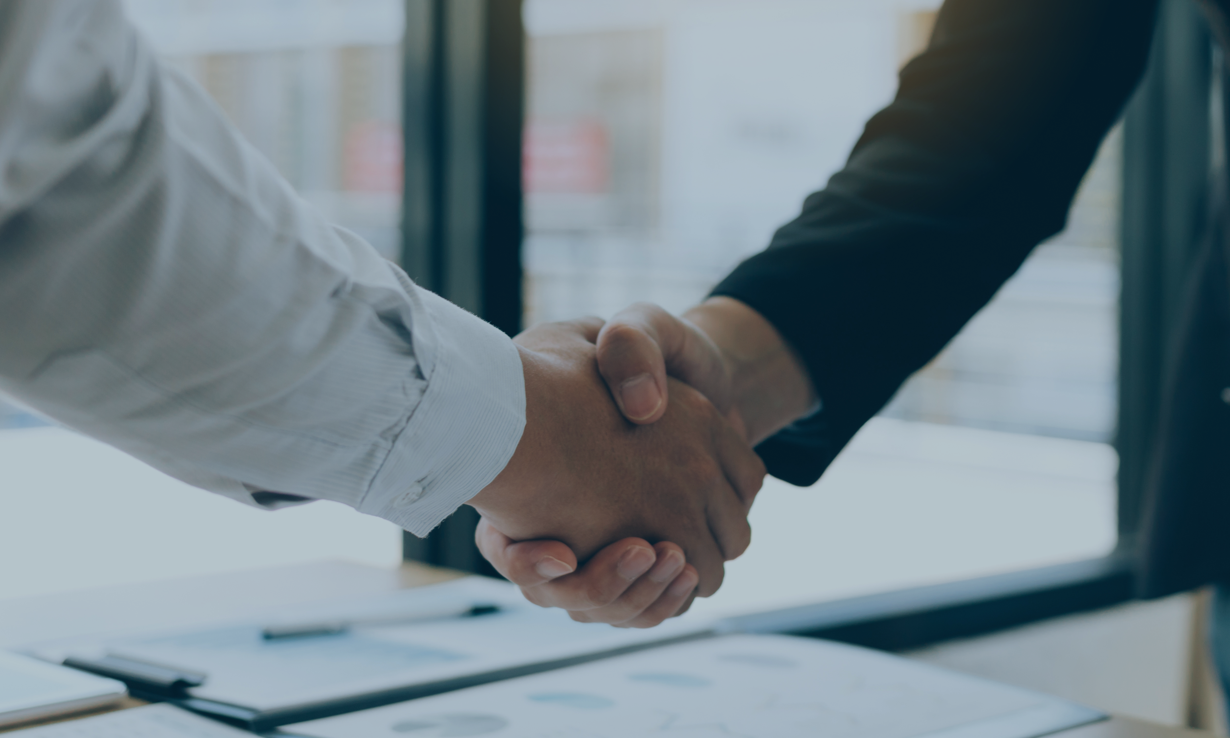 2 people shaking hands indicating an official partnership. 